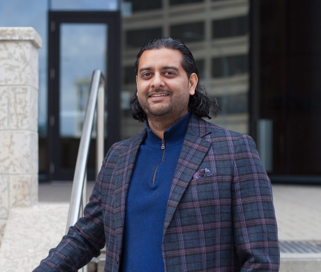 Dilpreet, commercial realtor outside a building in Winnipeg